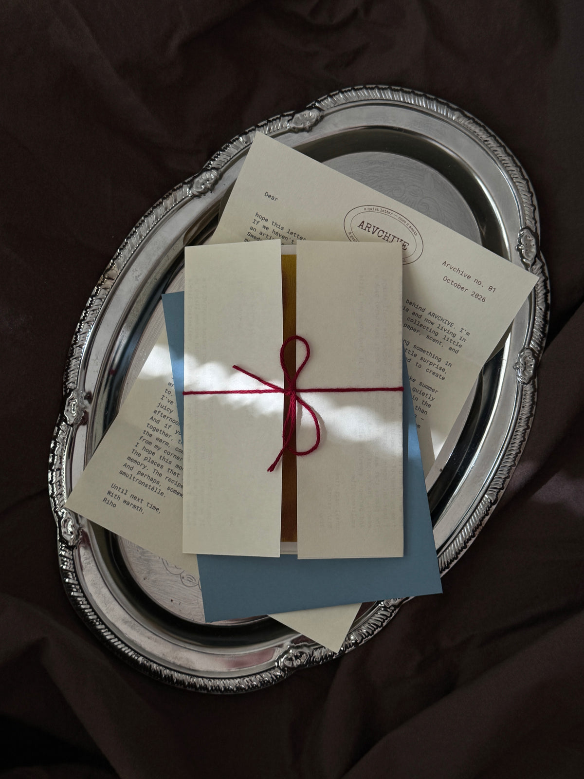 Inside an ARVCHIVE art mail club envelope with a handwritten letter, collectible artwork, recipe mail card, journaling prompts, bookmark, and sensory paper details. A slow living snail mail subscription designed to create a meaningful connection through letters, creativity, and memories
