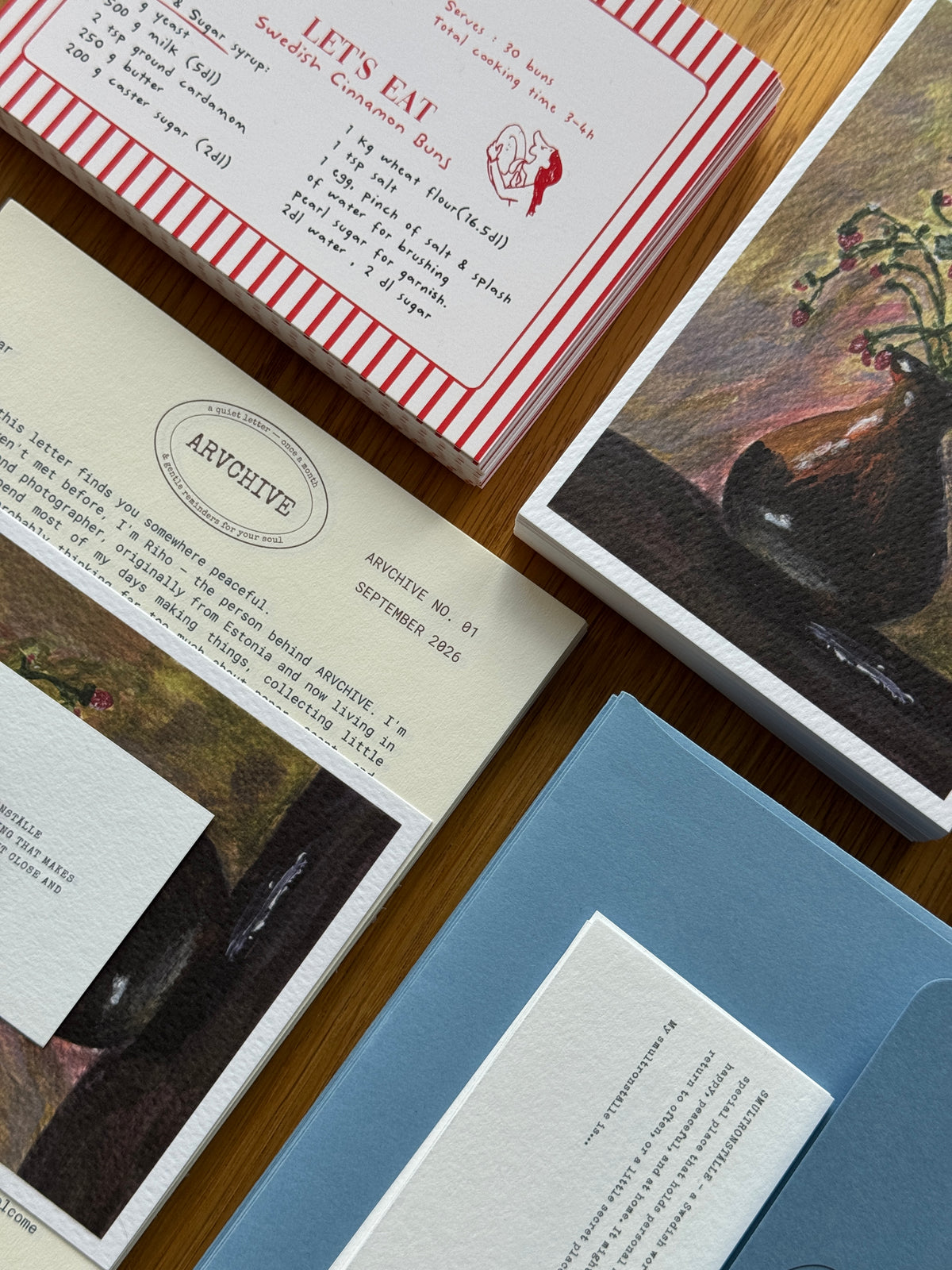 Inside an ARVCHIVE art mail club envelope with a handwritten letter, collectible artwork, recipe mail card, journaling prompts, bookmark, and sensory paper details. A slow living snail mail subscription designed to create a meaningful connection through letters, creativity, and memories