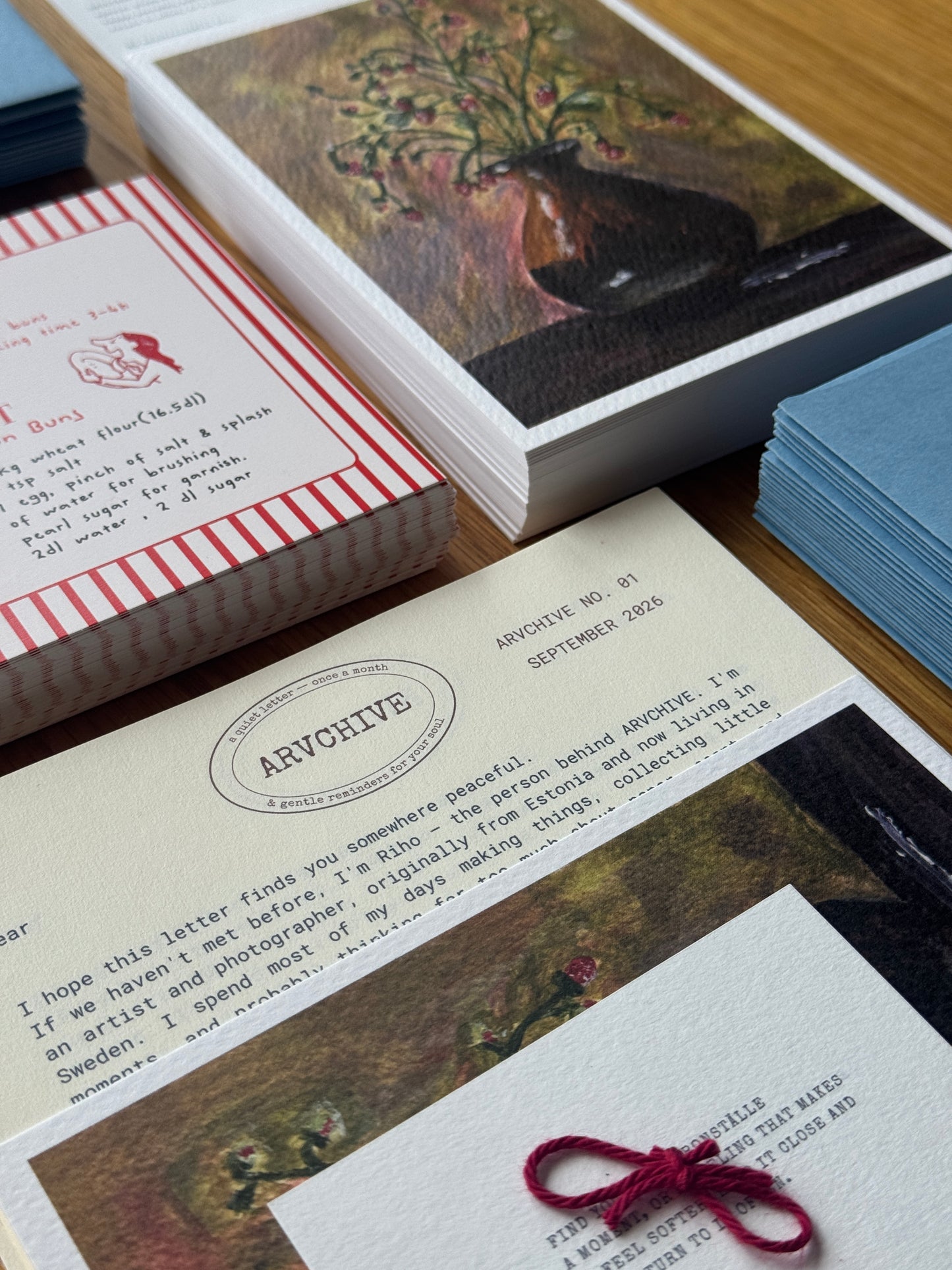 Inside an ARVCHIVE art mail club envelope with a handwritten letter, collectible artwork, recipe mail card, journaling prompts, bookmark, and sensory paper details. A slow living snail mail subscription designed to create a meaningful connection through letters, creativity, and memories